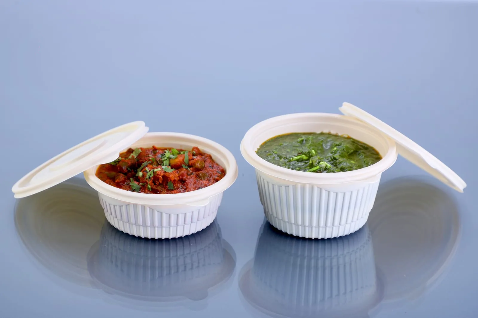 Eco Tray 350 ml Round Container with Lid and 500 ml Round Container with Lid, codes 7063 and 7065, holding a red curry and a green curry