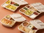 Oracle Group Eco Tray cornstarch compartment meal trays filled with Indian meals