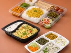 Oracle Group PP compartment meal boxes filled with rice, curries, rotis and salad