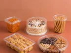 Clear Oracle PET round and square containers holding namkeen, cake, breadsticks, baklava and dry fruits
